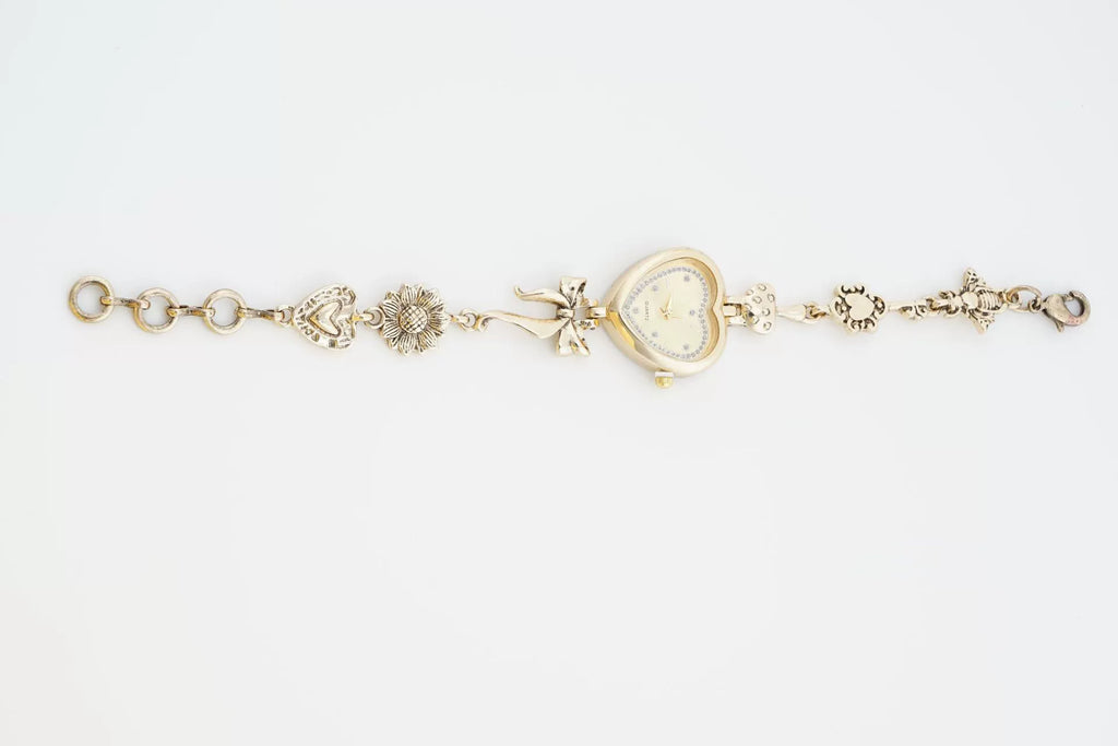 Heart Case Bracelet Watch — Gold-Tone, Crystal Bezel, Champagne Dial & Bow Charm Chain, Women