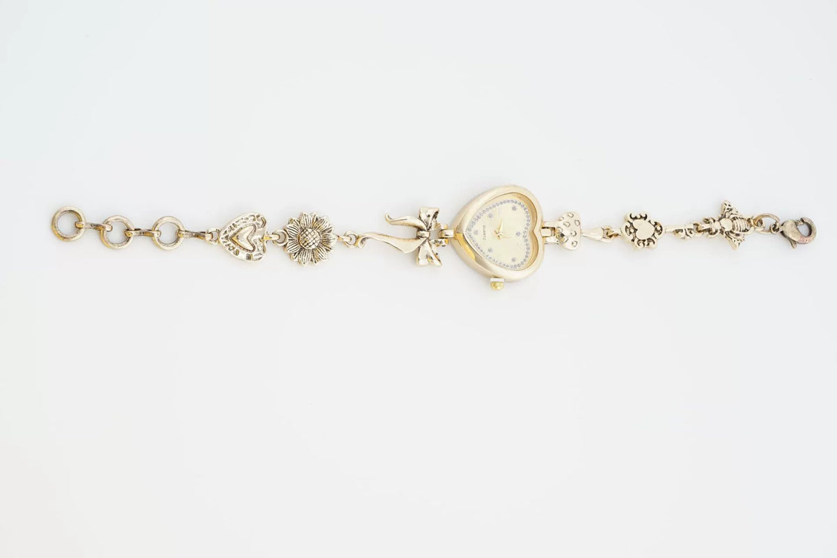Heart Case Bracelet Watch — Gold-Tone, Crystal Bezel, Champagne Dial & Bow Charm Chain, Women