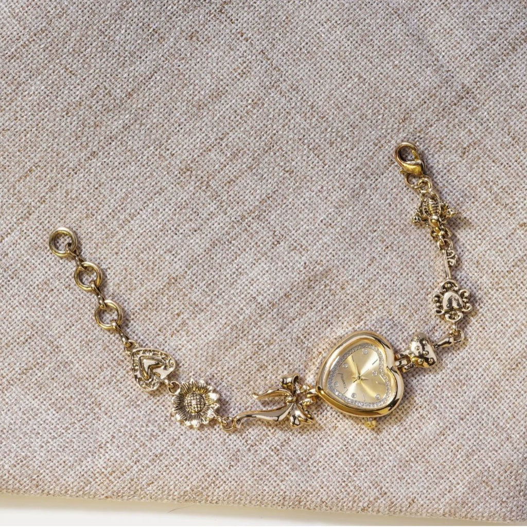 Heart Case Bracelet Watch — Gold-Tone, Crystal Bezel, Champagne Dial & Bow Charm Chain, Women