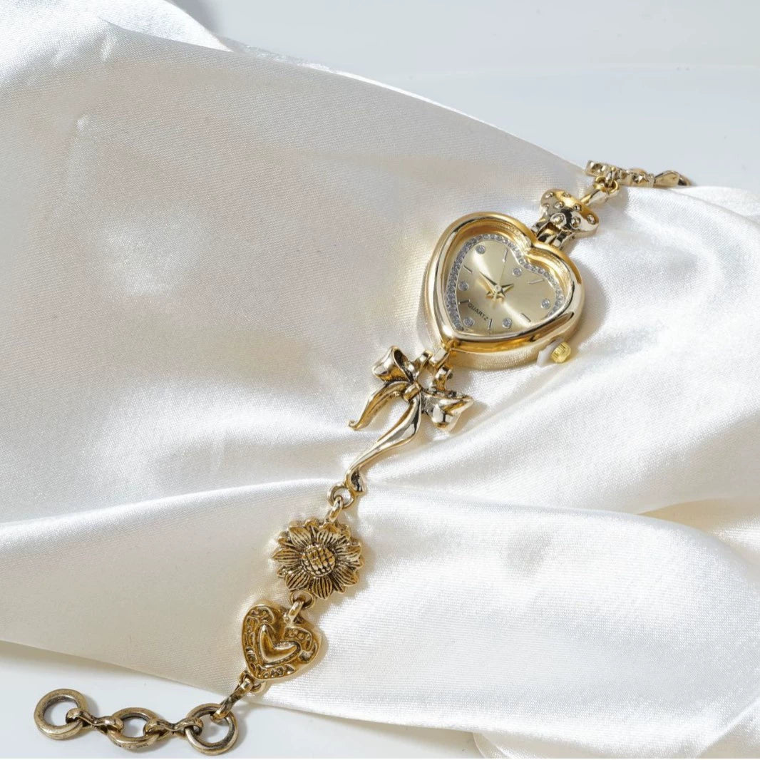 Heart Case Bracelet Watch — Gold-Tone, Crystal Bezel, Champagne Dial & Bow Charm Chain, Women