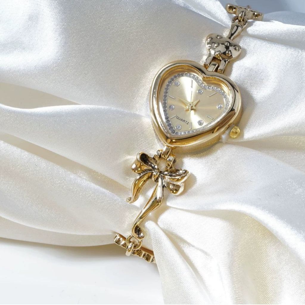 Heart Case Bracelet Watch — Gold-Tone, Crystal Bezel, Champagne Dial & Bow Charm Chain, Women